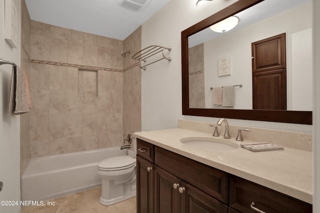 full bathroom with tiled shower / bath, vanity, tile patterned flooring, and toilet