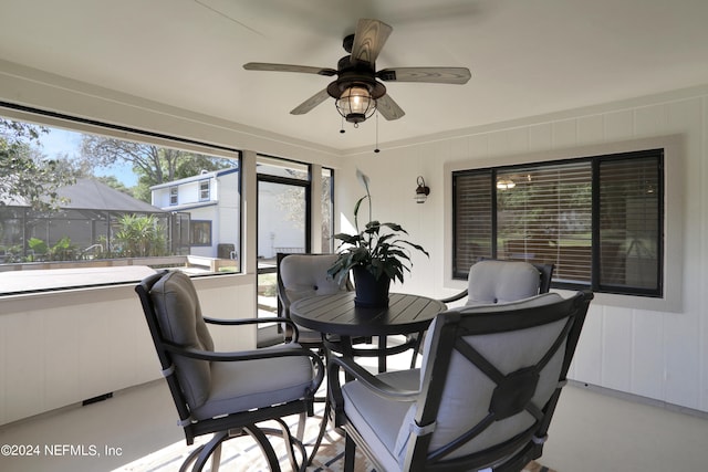 sunroom featuring ceiling fan