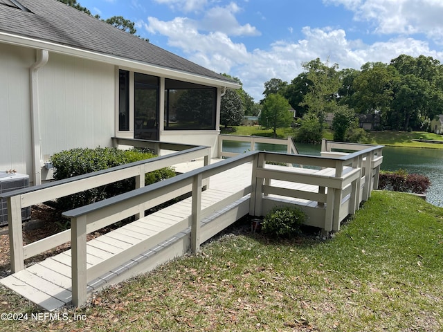 wooden terrace with a lawn, a water view, and central AC