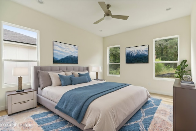 bedroom featuring multiple windows and ceiling fan