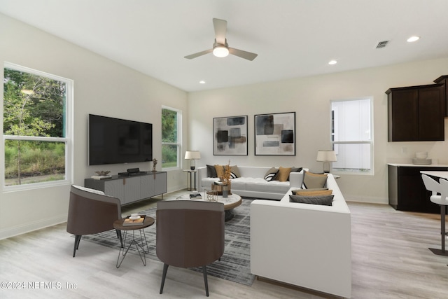 living room featuring light wood-type flooring and ceiling fan