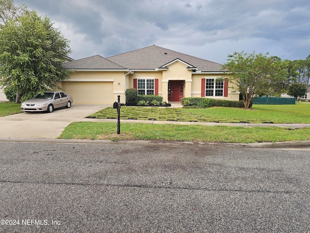 single story home featuring a front yard and a garage