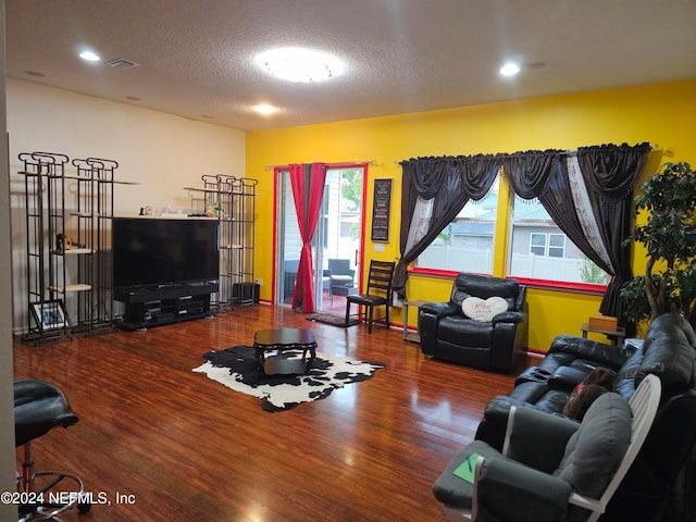 living room featuring a textured ceiling and hardwood / wood-style flooring