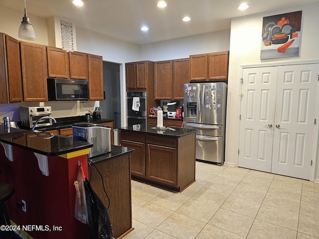 1075 Wetland Ridge Cir, Middleburg, FL 32068 - kitchen featuring double wall oven, a kitchen island, black microwave, stainless steel fridge with ice dispenser, and a peninsula