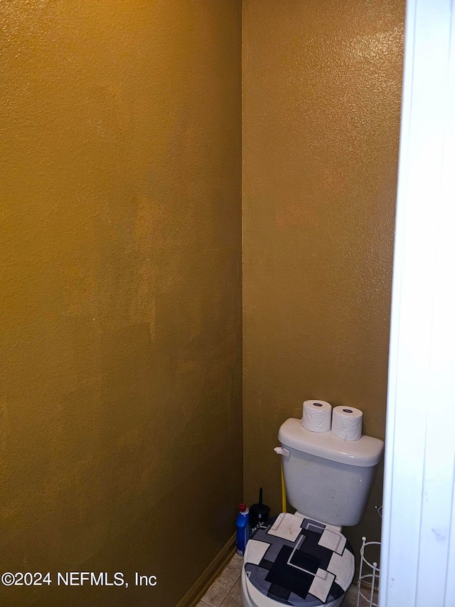 bathroom featuring toilet and tile patterned floors