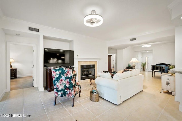 tiled living room with ornamental molding and a fireplace