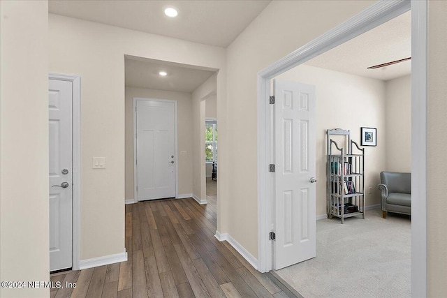 hall with hardwood / wood-style floors