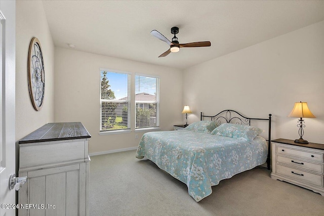 bedroom with ceiling fan and light colored carpet