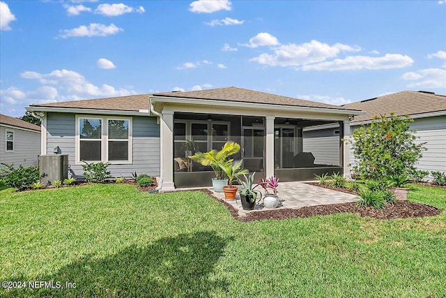 back of house with a yard, a patio, central AC unit, and a sunroom