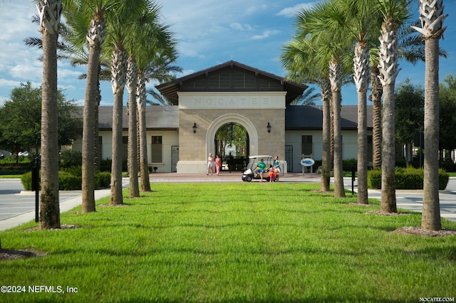 rear view of house featuring a lawn