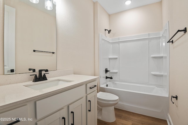 full bathroom with toilet, shower / tub combination, wood finished floors, and vanity