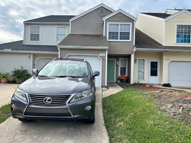 view of front of house with a garage and a front yard