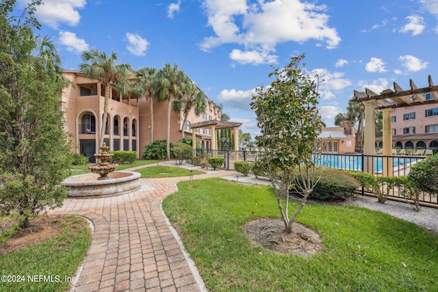 5375 Ortega Farms Blvd Unit 506, Jacksonville, FL 32210 - surrounding community with fence, a swimming pool, a yard, and a pergola