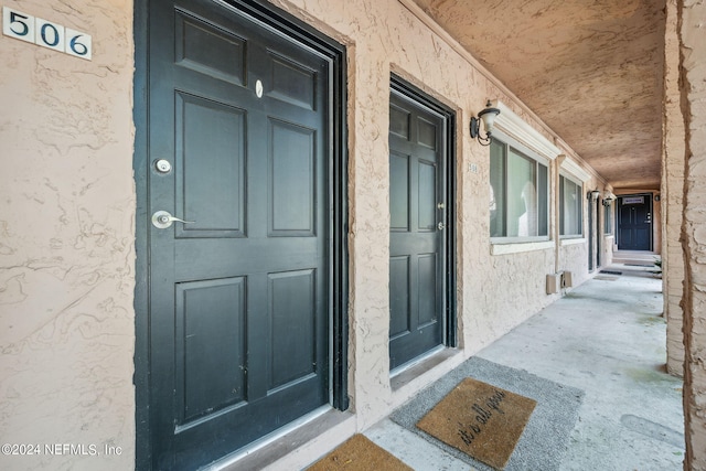 view of exterior entry featuring covered porch