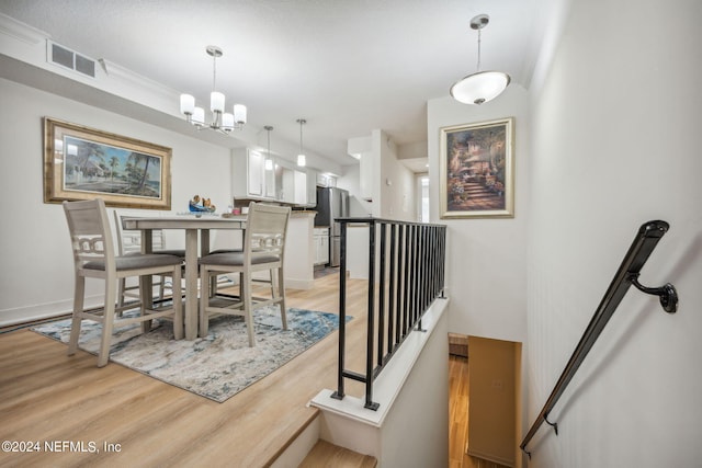 dining area featuring a chandelier and light hardwood / wood-style floors