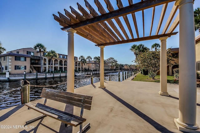 view of patio featuring a water view and a pergola