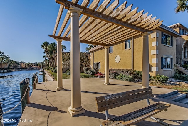 view of patio / terrace with a water view and a pergola