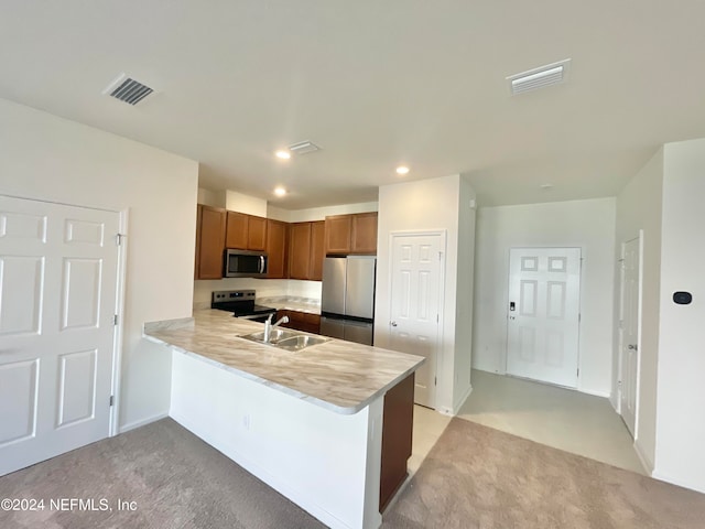 kitchen featuring light carpet, stainless steel appliances, sink, and kitchen peninsula