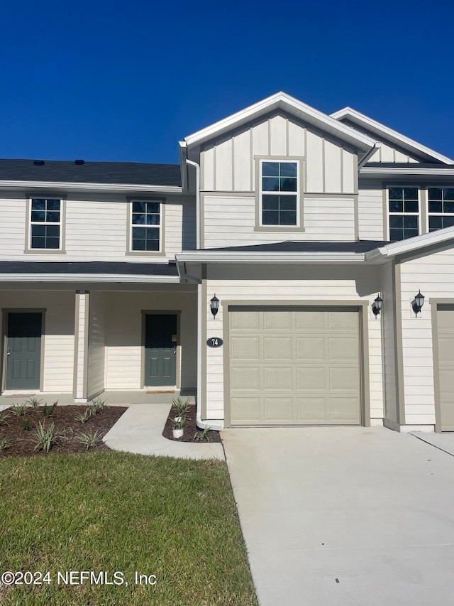 view of front of home with a garage and a front lawn