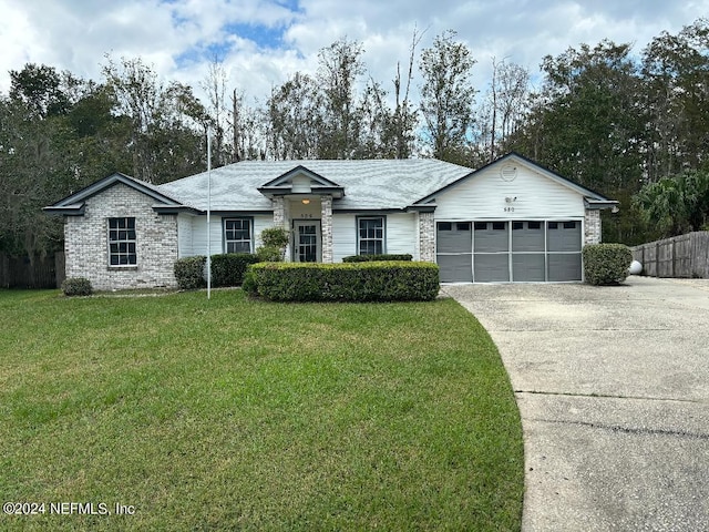 ranch-style house featuring a front yard and a garage