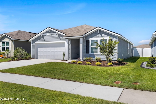 view of front facade with a front yard and a garage