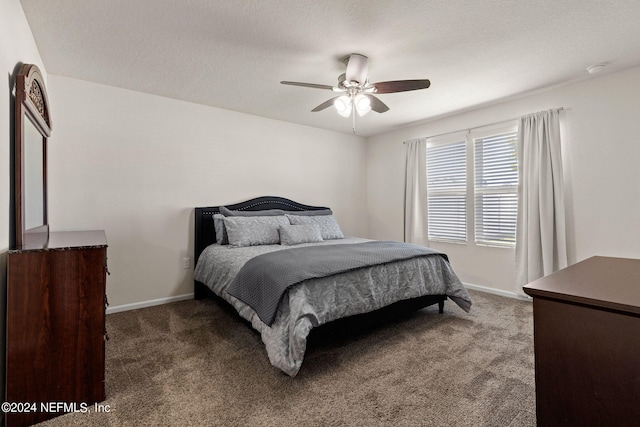 carpeted bedroom featuring ceiling fan and a textured ceiling