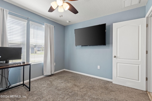 office space featuring carpet, ceiling fan, and a textured ceiling