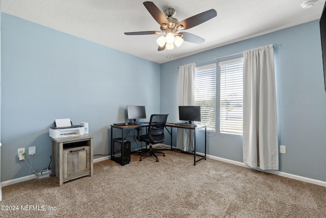 home office featuring ceiling fan, light colored carpet, and a textured ceiling