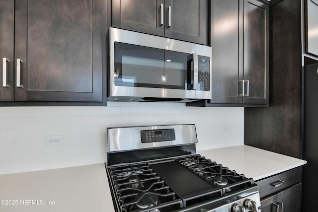 kitchen with tasteful backsplash, dark brown cabinetry, and appliances with stainless steel finishes