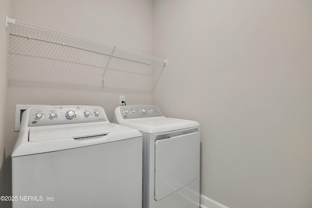 clothes washing area with washing machine and dryer