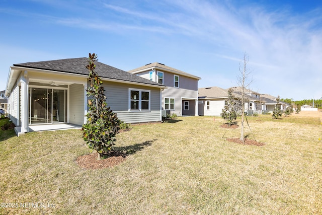 rear view of house with a yard and a patio area