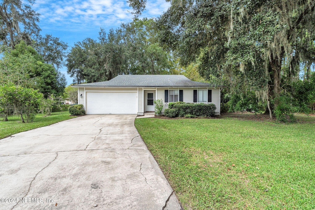 ranch-style house with a garage and a front yard