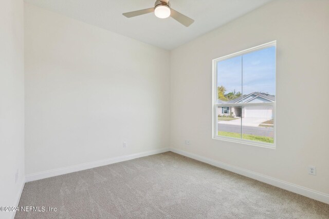 unfurnished room with ceiling fan and carpet flooring