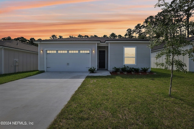 view of front of property with a lawn and a garage