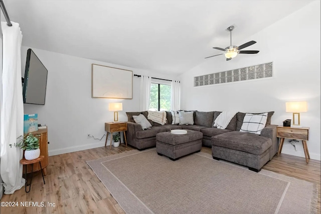 living room featuring light wood-type flooring, lofted ceiling, and ceiling fan