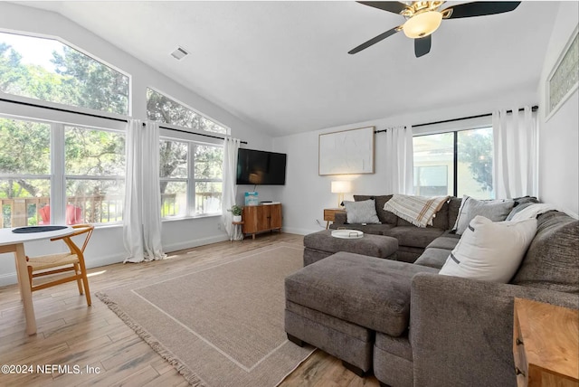 living room with ceiling fan, light wood-type flooring, and a healthy amount of sunlight