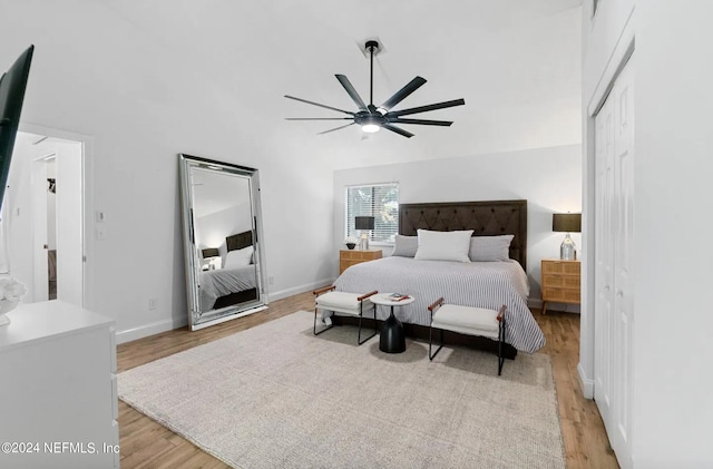 bedroom with ceiling fan, a closet, and light hardwood / wood-style floors