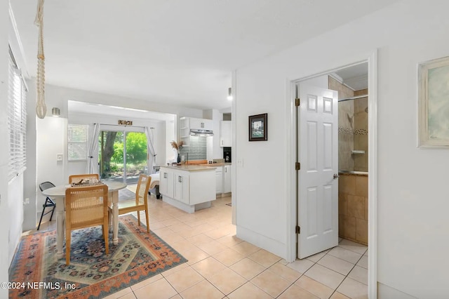 dining area featuring light tile patterned flooring