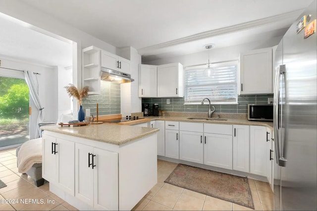 kitchen with appliances with stainless steel finishes, a healthy amount of sunlight, white cabinetry, and sink