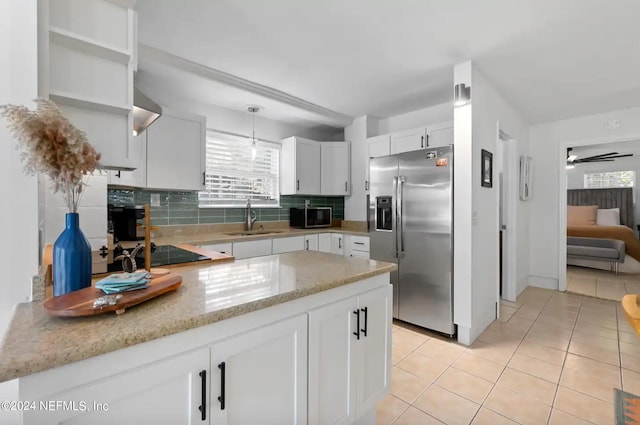 kitchen featuring sink, white cabinetry, hanging light fixtures, appliances with stainless steel finishes, and ceiling fan