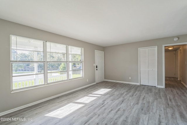 unfurnished room with light hardwood / wood-style floors