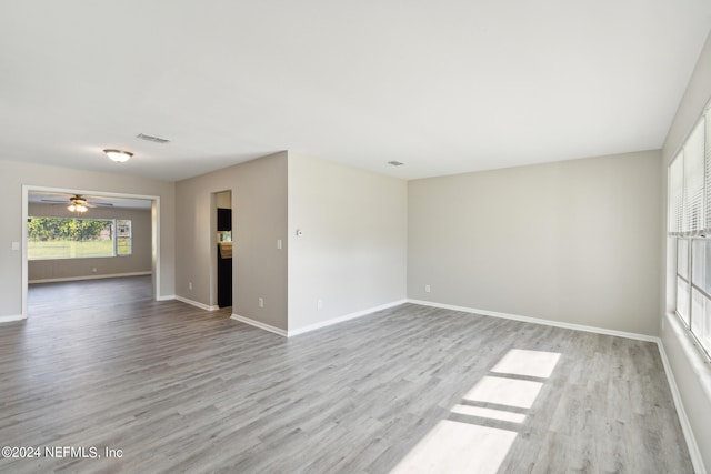 empty room with light hardwood / wood-style floors and ceiling fan