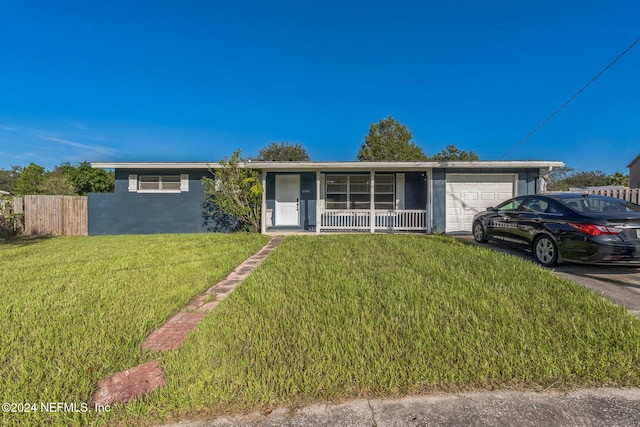 ranch-style house with covered porch, a front yard, and a garage