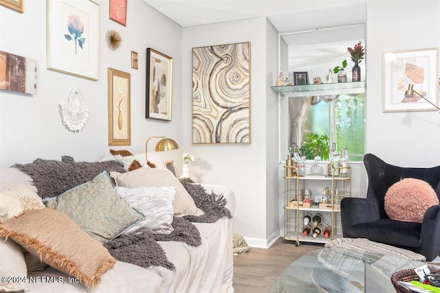 bedroom featuring wood finished floors and baseboards