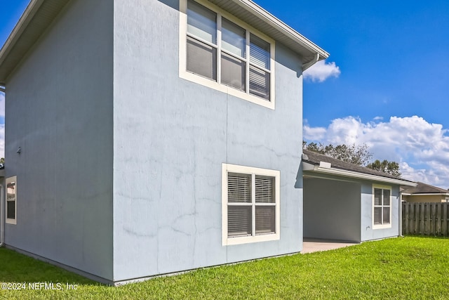 rear view of property with a yard