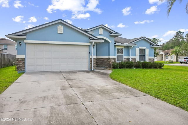 view of front of home with a front lawn and a garage