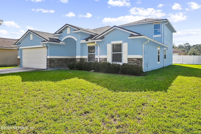 view of front of house with a front yard and a garage