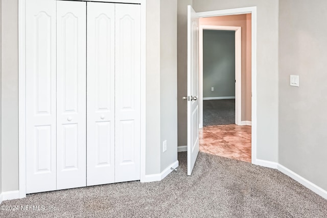 unfurnished bedroom featuring a closet and carpet flooring