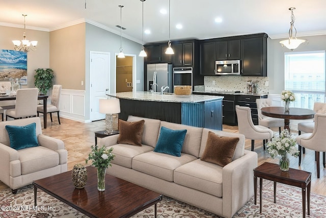 living room with sink, vaulted ceiling, crown molding, a notable chandelier, and light hardwood / wood-style flooring