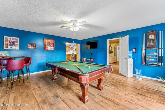 playroom featuring ceiling fan, hardwood / wood-style flooring, billiards, and a textured ceiling